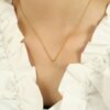 Pavé Horseshoe Pendant Necklace product image 4 Pavé horseshoe pendant necklace worn at the collarbone with a neutral top