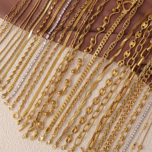 Essential Stainless Steel Chain Necklace Collection product image 1 Selection of gold-tone stainless steel chain necklaces arranged on ivory and cocoa fabric