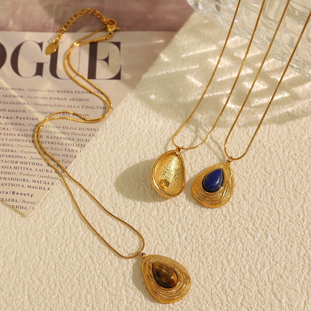 Gold-tone sculpted stone pendant necklaces