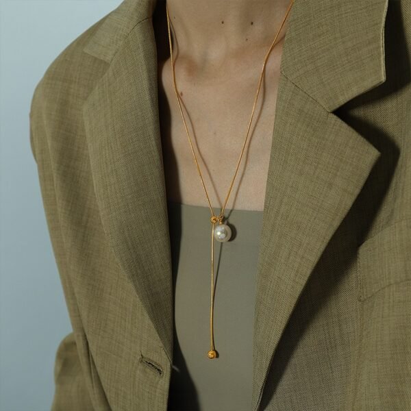 Pearl Drop Adjustable Y Necklace product image 5 Pearl drop adjustable Y necklace worn with a neutral blazer