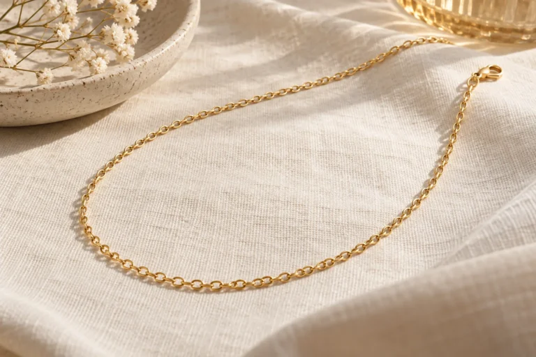 AI illustration of a fine chain necklace and generic clasp supported on cream cloth